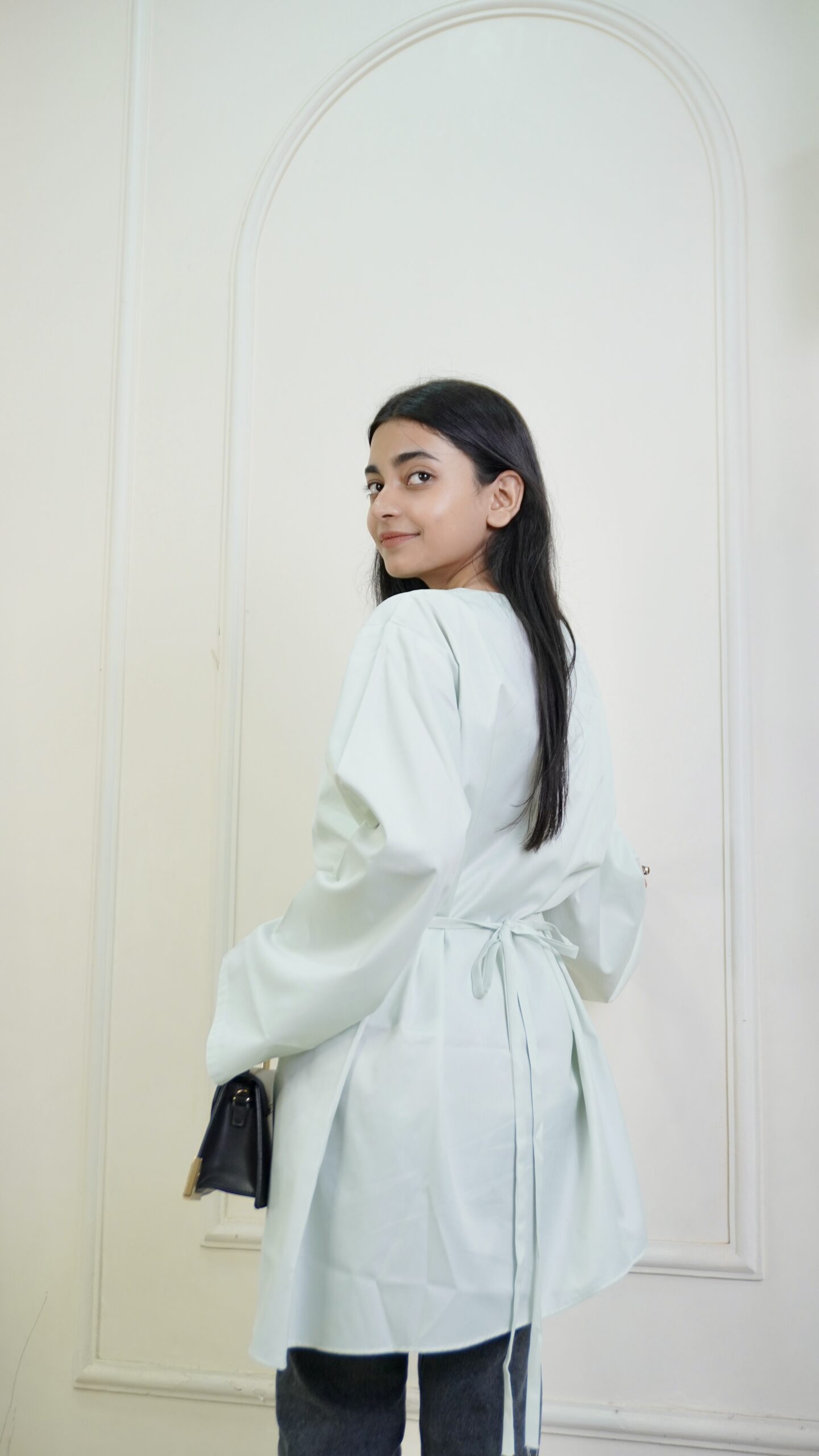 Woman wearing Tinker Asymmetric Top in mint green